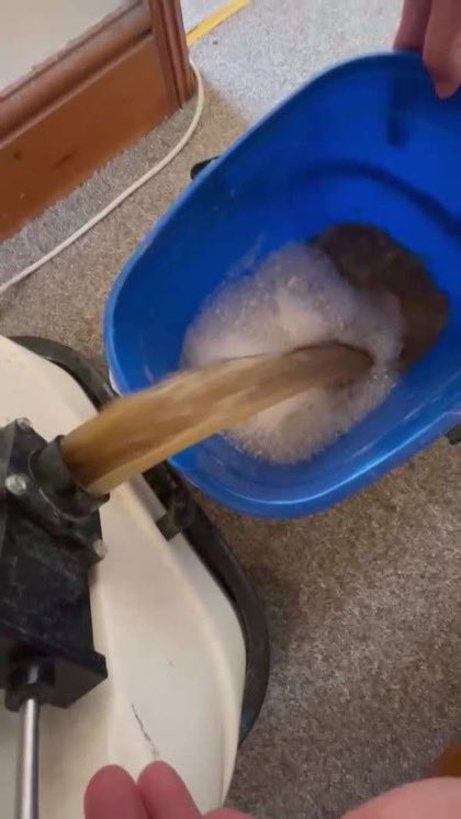 Waste water pouring out of the extraction tank into a bucket