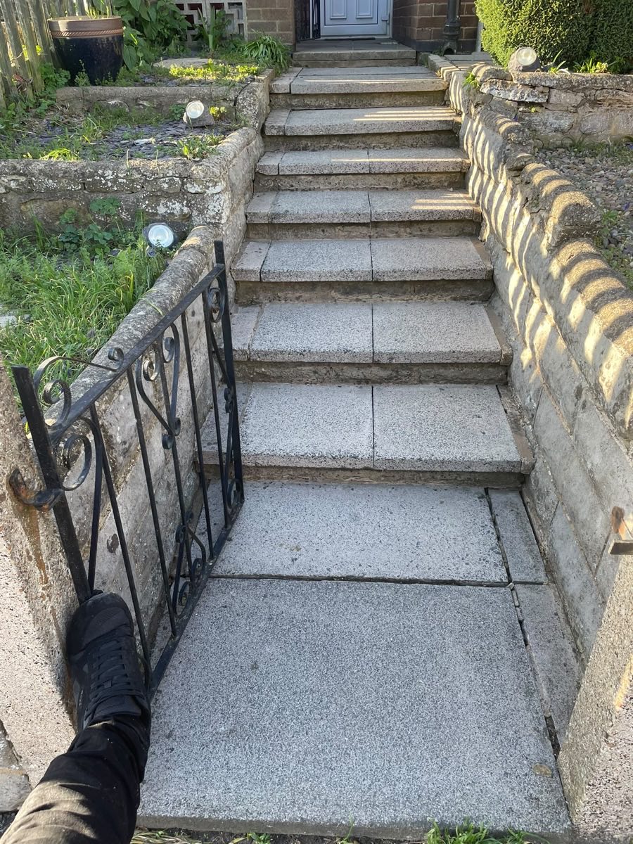 Stone steps and a path after cleaning, pale grit showing