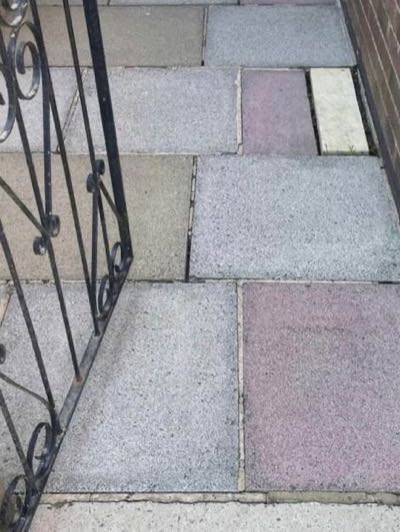 The same doorstep and path after cleaning, joints clear