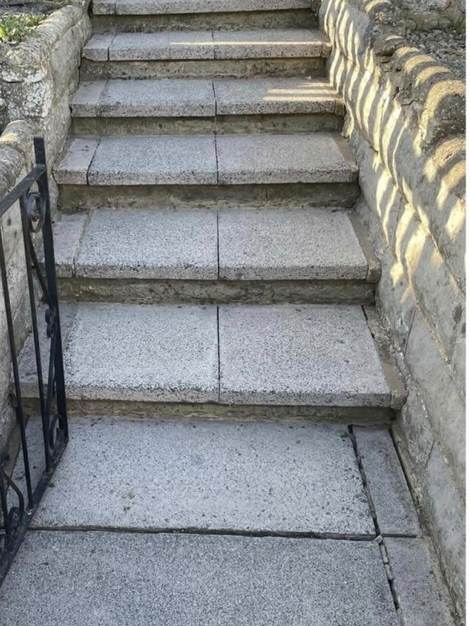 The same stone steps after cleaning, pale grit exposed
